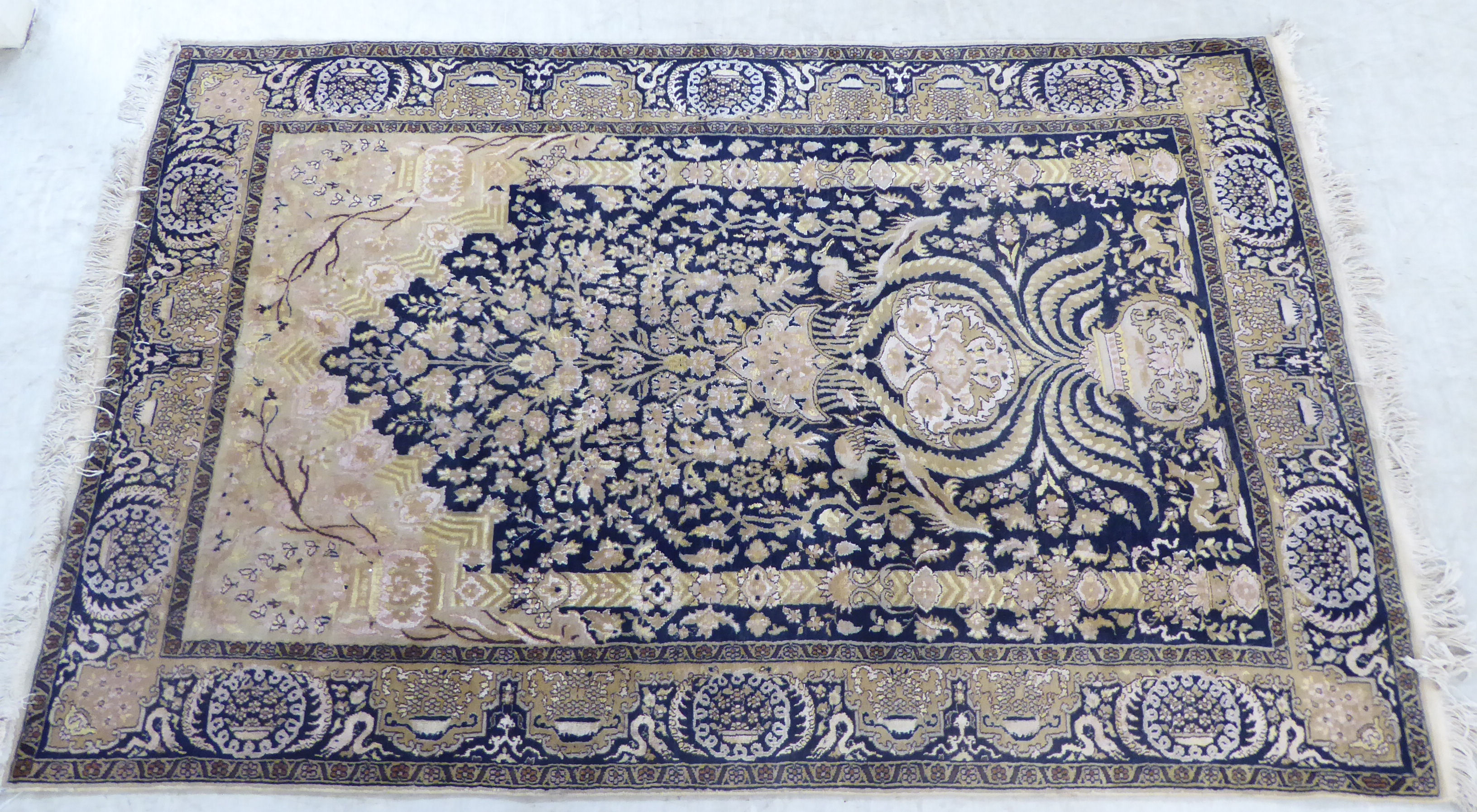 An Oriental part silk prayer rug, decorated with a vase of flowers,