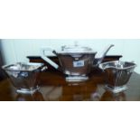 An Art Deco three piece silver plated tea set comprising a teapot,