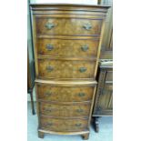 A modern Georgian design mahogany and walnut finished bow front six drawer tallboy,