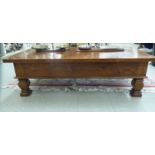 A modern hardwood coffee table, the top over a single drawer,