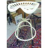 A modern cream painted iron stool,