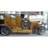 A child's mid 20thC scratch-built wooden toy car SR