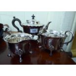 A three piece silver plated tea set of cauldron design with cut, flared rims comprising a teapot,