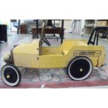 A child's yellow and black painted steel pedal tow truck,