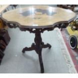 An early 20thC North European profusely carved walnut pedestal table,
