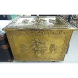 A mid 20thC embossed brass clad wooden coal box, decorated with ships,