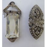 A white metal backed Victorian style hair clip,