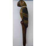 An Edwardian carved and painted wooden parasol handle, fashioned as a parrot with glass eyes,