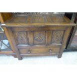 A mid 20thC stained and carved, tri-panelled oak coffer with straight sides,