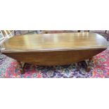 A mid 20thC stained oak wake style coffee table with D-shaped fall flaps,
