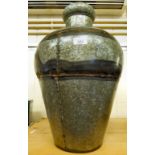 A galvanised metal vase of tapered,