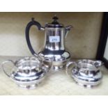 A three piece silver plated tea set of squat, bulbous form with gadrooned rims comprising a teapot,