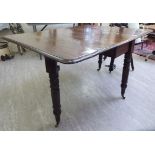 An early 20thC Georgian style mahogany drop leaf dining table,