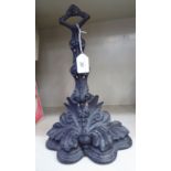 A late Victorian black painted, floral and foliate cast iron door porter,