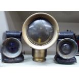 A pair of front and rear carbide bicycle lamps, one with a clear bullseye glass,