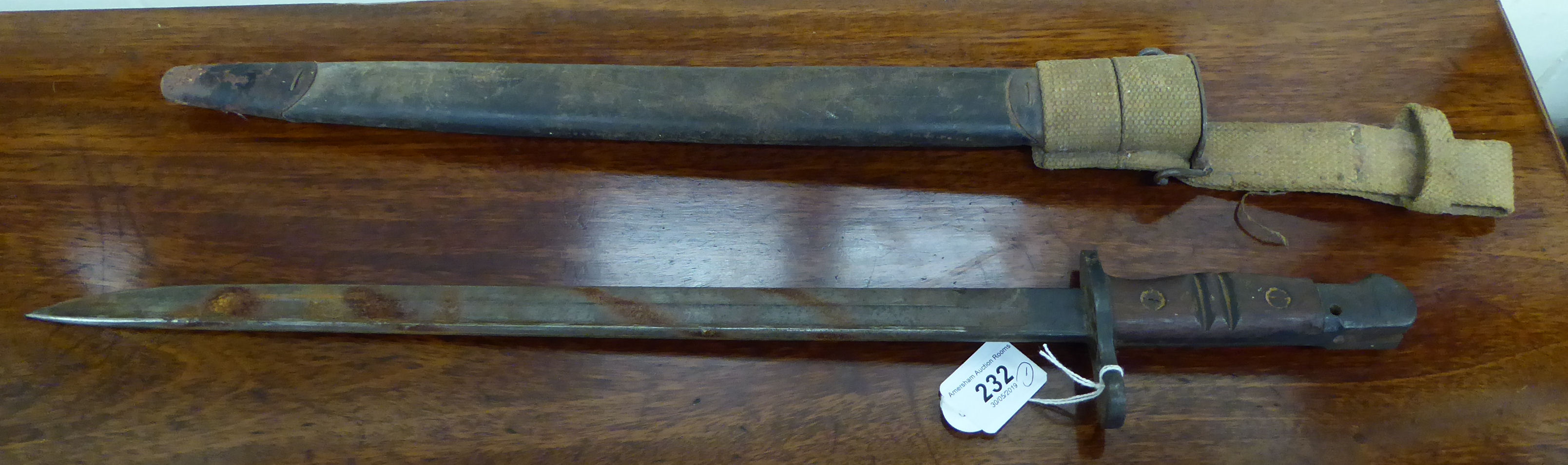 A Great War period bayonet the partly serrated blade 24''L (Please Note: this lot is offered