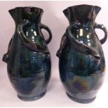 A pair of early 20thC Baron pottery green glazed earthenware vases of ovoid form,