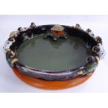 A late 19th/early 20thC Japanese moulded and part drip glazed, high fired earthenware shallow dish,