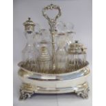 An early Victorian seven piece table cruet, the silver carrier of oval ogee form,