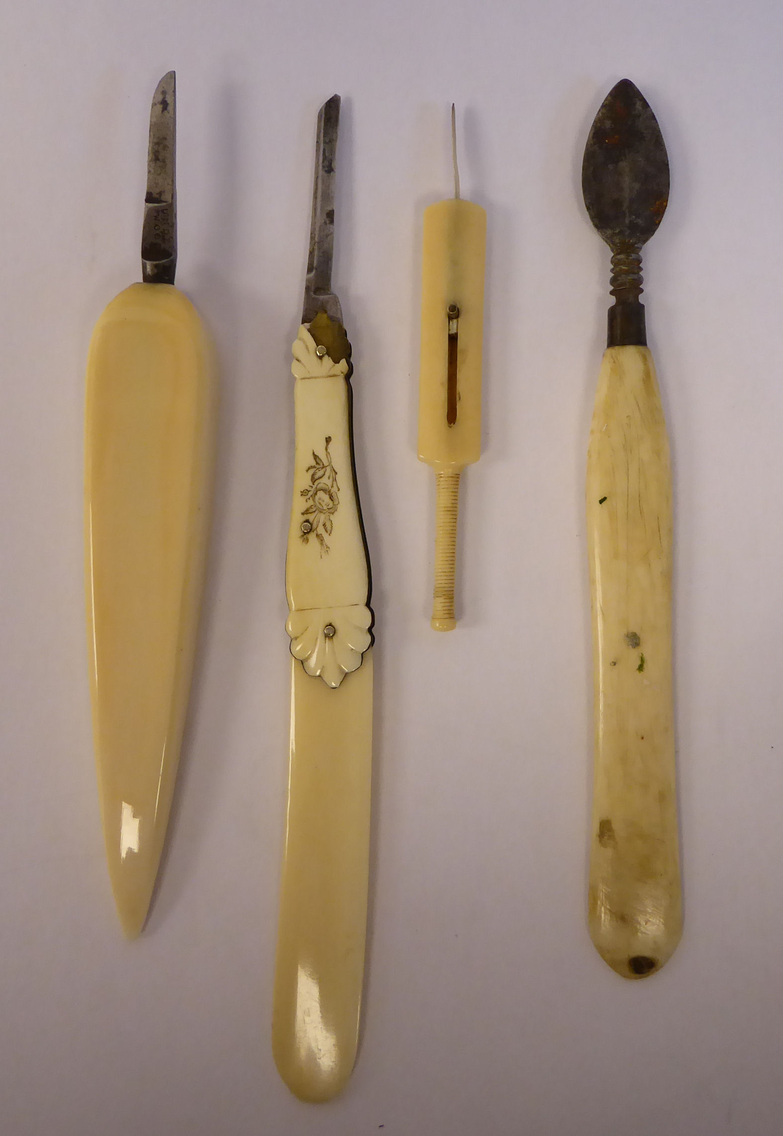 A late Victorian ivory paper knife with a folding quill cutter in the