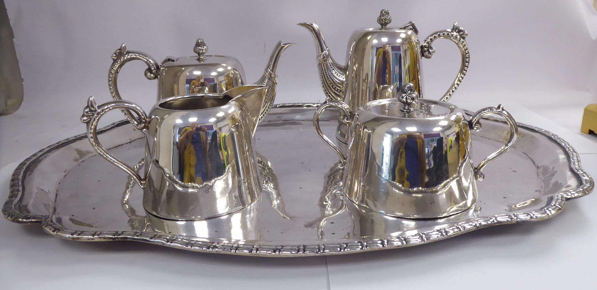 A Peruvian JPC four piece silver coloured metal tea set of round,
