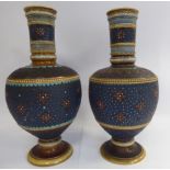 A pair of Mettlach stoneware vases of shouldered baluster form, each having a wide straight neck,