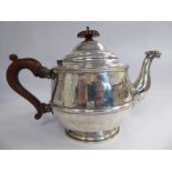 A silver teapot of tapered, bulbous form with an animal's head on the S-shaped spout,