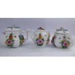 A 20thC miniature three piece porcelain tea set for one, in the manner of Meissen,