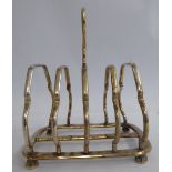 An Edwardian four division silver wire framed toastrack with a ring handle,