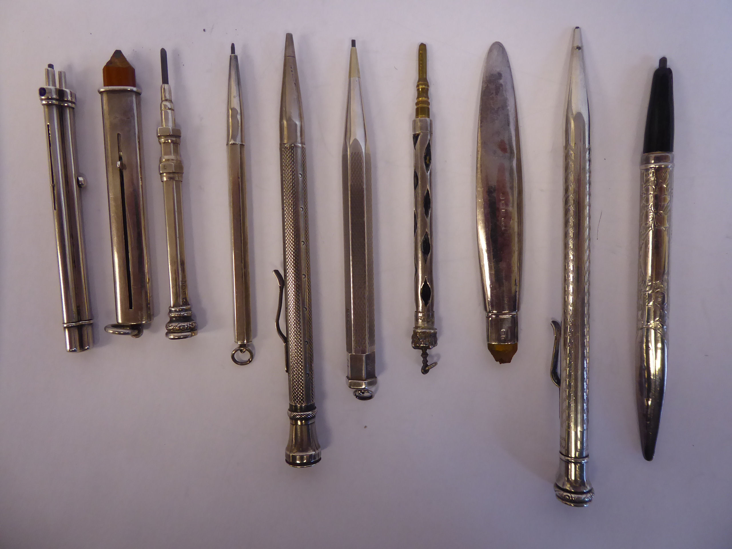 Ten items of 'vintage' silver, silver coloured and white metal cased writing equipment, viz.