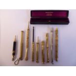 Nine 'vintage' combination dip pens and propelling pencils, in yellow/white metal cases,