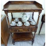 A late Victorian rosewood effect three tier what-not,