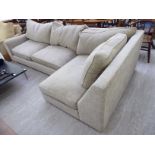 A modern L-shaped four person oatmeal coloured, textured effect fabric upholstered settee,