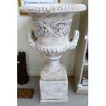 A cream coloured painted composition stone campana shaped pedestal vase,