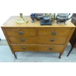 A 1920s light oak four drawer dressing chest,