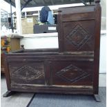 A late 19thC Gothic inspired stained and carved, panelled oak crib,