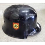 A World War II German Fire Police helmet,