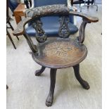 A 1930s Italian inspired carved oak captain's style twin fish carved, splat-back desk chair,