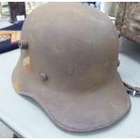 A German steel double decal transitional helmet (Please Note: this lot is offered subject to the