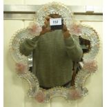 A 20thC Murano glass mirror, the shaped plate set in a moulded,