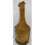 A half bottle of Benedictine with original paper wrapping bearing a label 'Budget-April 1948'