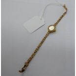 A lady's 9ct gold cased Accurist bracelet watch with a baton dial 11