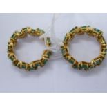 A pair of yellow metal (possibly 22ct gold) emerald set interlocking rings 11