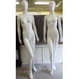 A pair of moulded white plastic shop window mannequins,