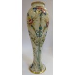 A Moorcroft (for Macintyre) pottery vase of slender, waisted baluster form, decorated with roses,