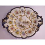 A Worcester gilded china oval plate, having a scroll moulded border,