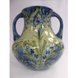 A Moorcroft pottery Florian Ware vase of waisted bulbous form with opposing loop handles,