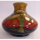 A Moorcroft pottery vase of squat, bulbous form with a wide neck and flared rim, shape No.