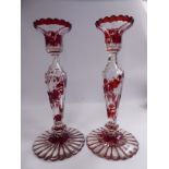 A pair of Continental clear, part blown and cut glass candlesticks having frilled,