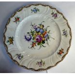 An early 20thC Dresden porcelain footed plate, having a raised, wrythen moulded border,